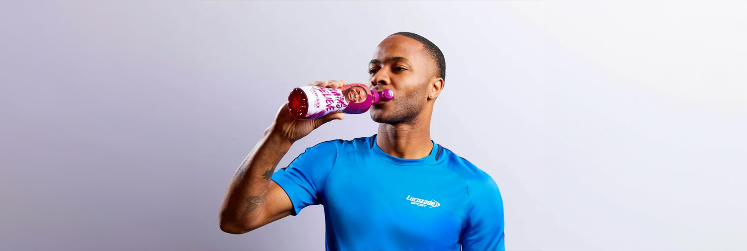 Man drinking Lucozade sport.